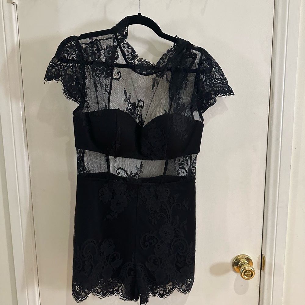 BEBE black lace romper/jumpsuit. Brand new with tags.